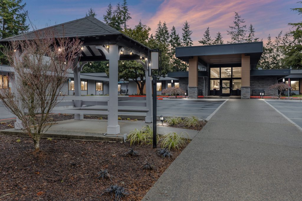 Exterior of Edmonds Care at dusk with covered entrance